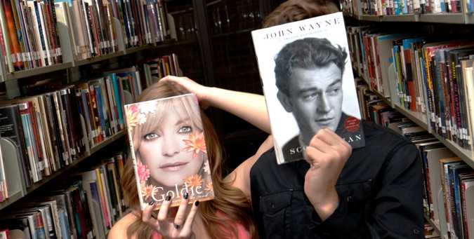 people with books in front of their faces