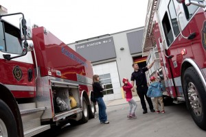 fireman showing trucks to kids