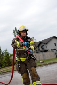 fireman carrying hose over shoulder