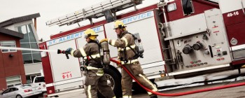 firemen simulating fighting fire