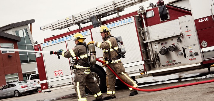 firemen simulating fighting fire