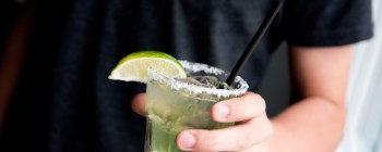 Margarita glass, with salt rim and lime